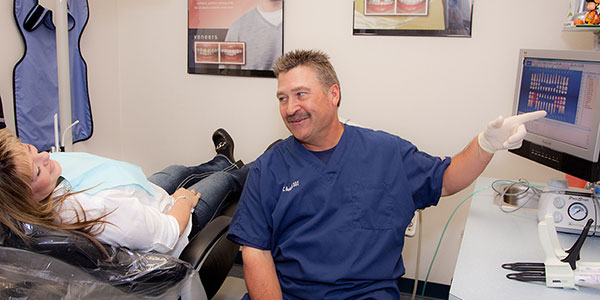 Dr. Charles Beckwell consulting his patient about a dental procedure.